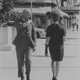 The original caption on this 1966 archival image explains: “A member of the International Society of Girl Watchers uses the ploy of wiping his shoulder in order to leer unnoticed at a passing woman.”